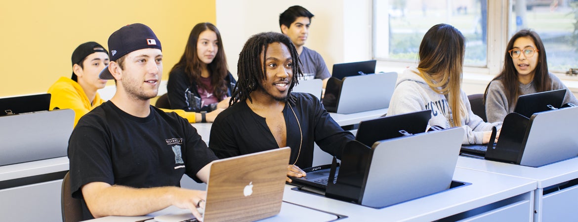 UCR students work on their laptops during a class.